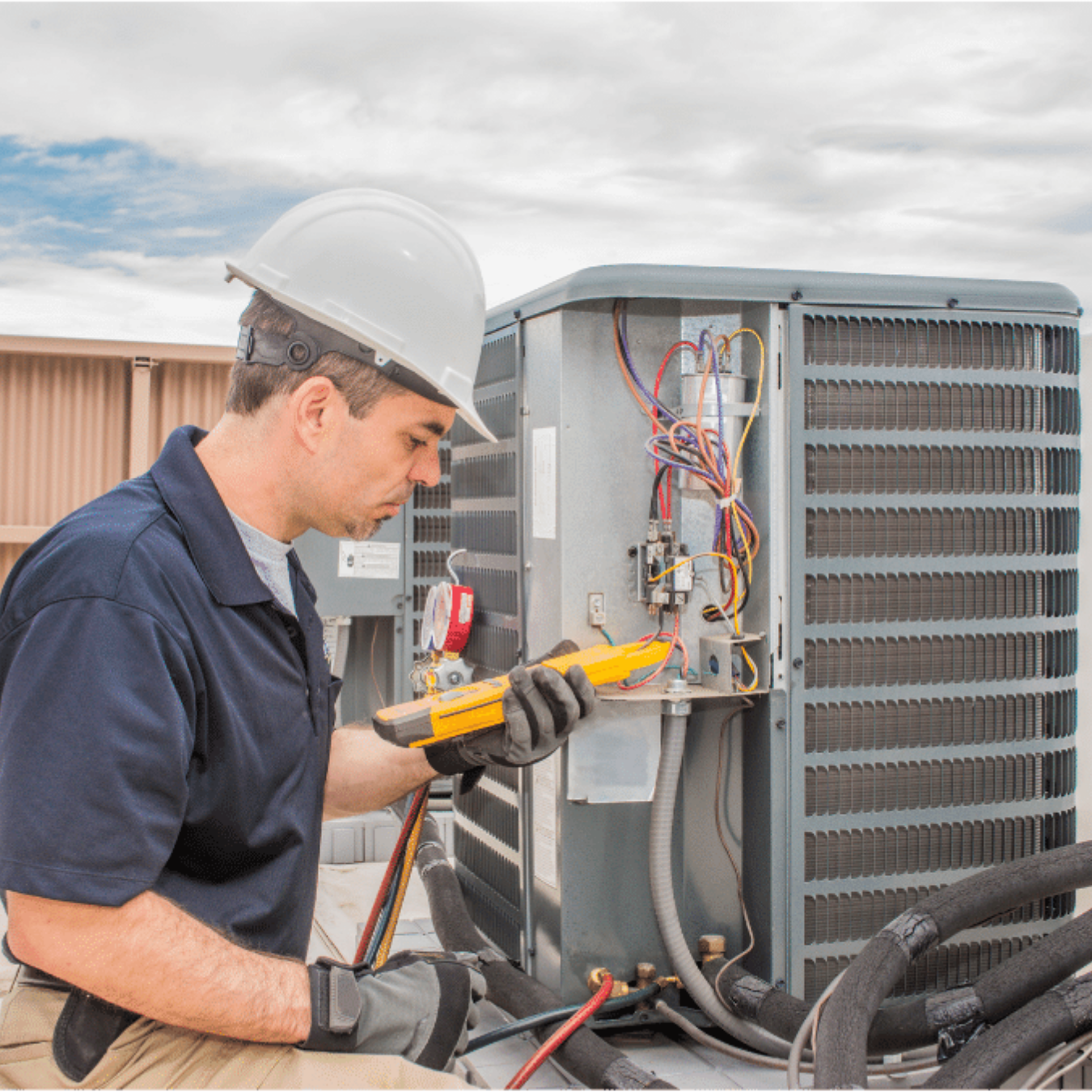 Amherstburg Heating & Cooling HVAC technician servicing a system
