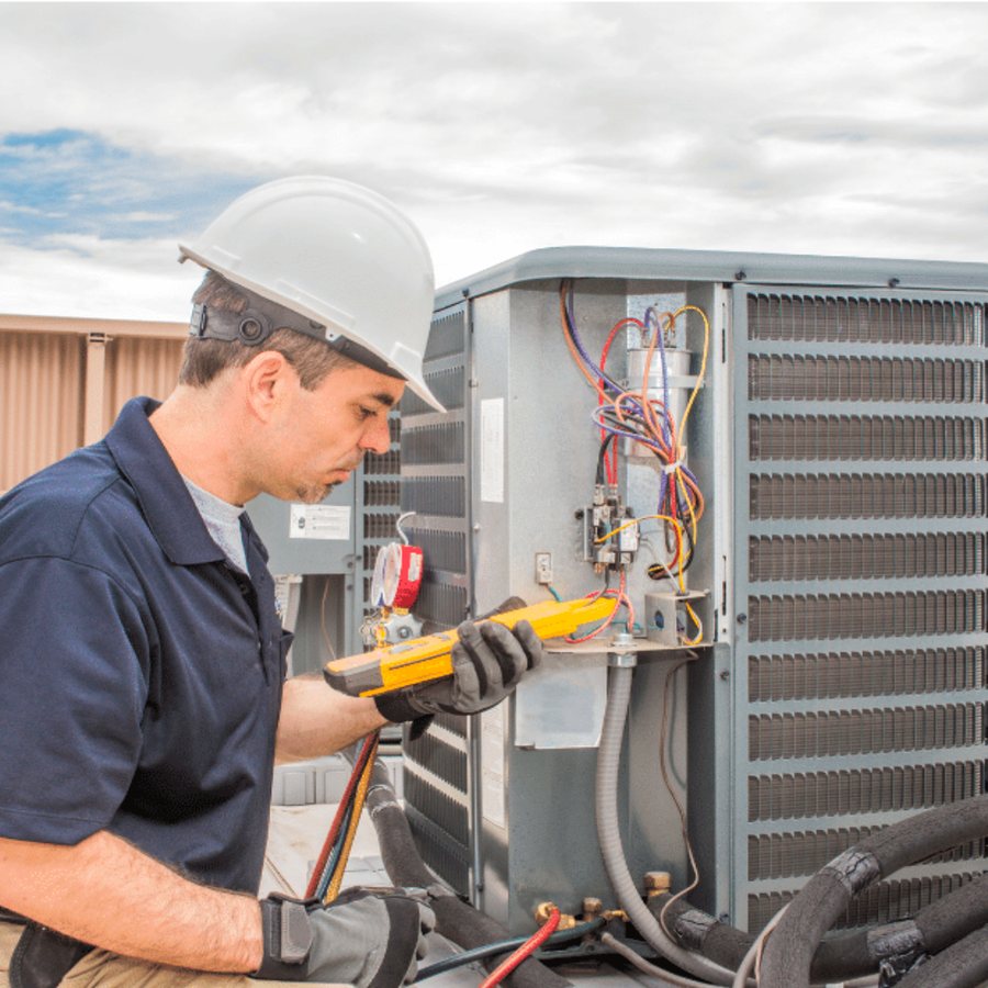 Amherstburg Heating & Cooling HVAC technician servicing a system